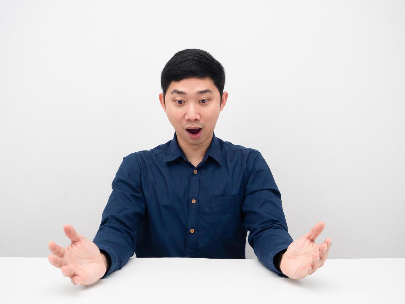 Man feeling excited looking on table copy space photo