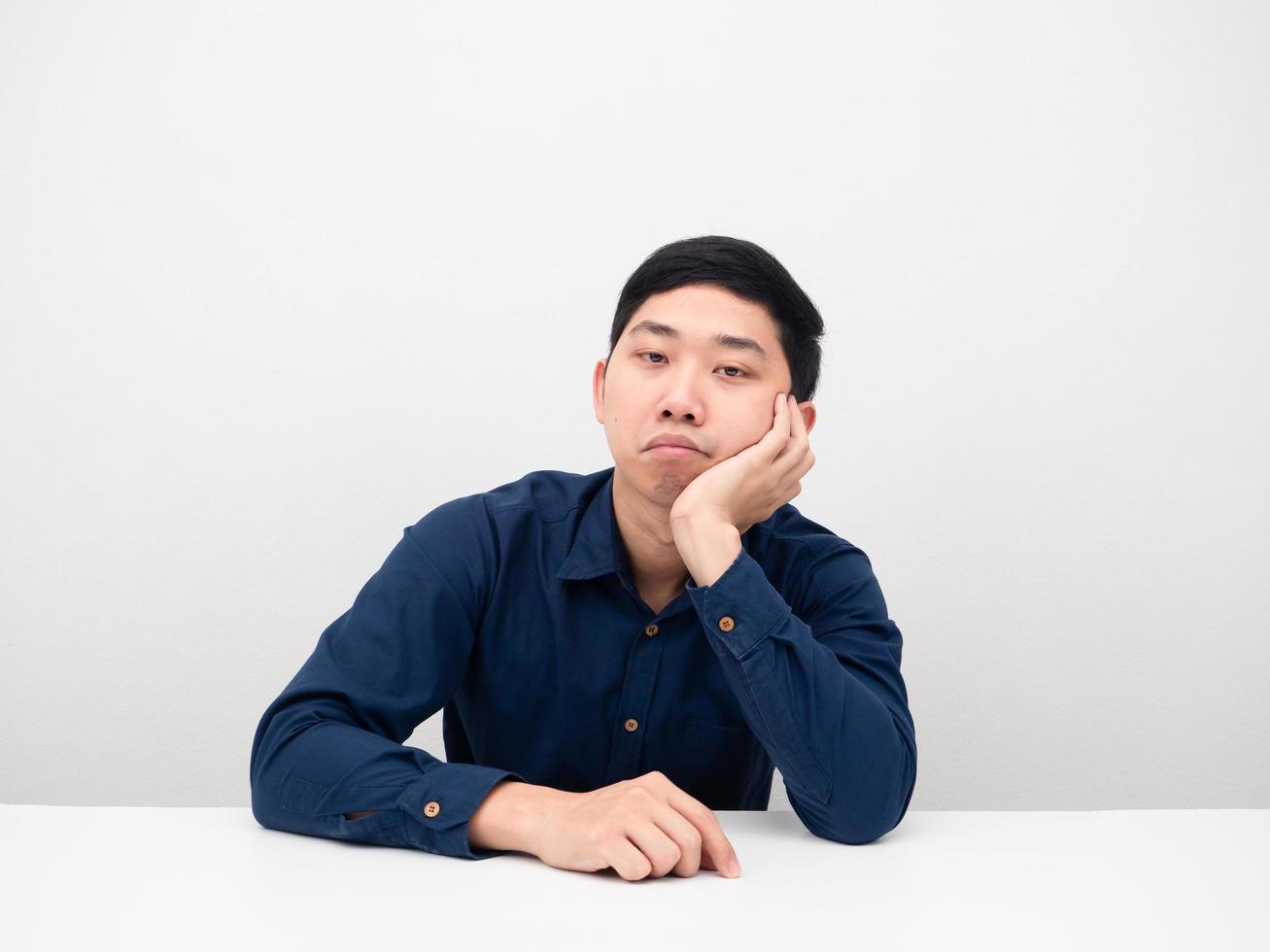 Businessman sitting and feeling bored looking at camera photo