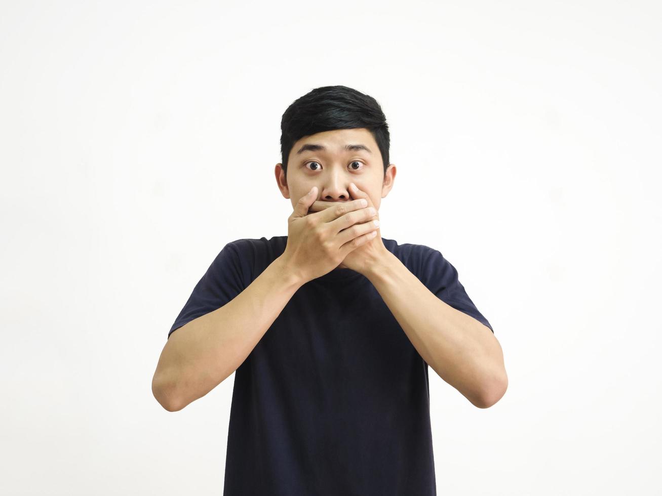 Asian man close his mouth by two hand amazed face on white background photo