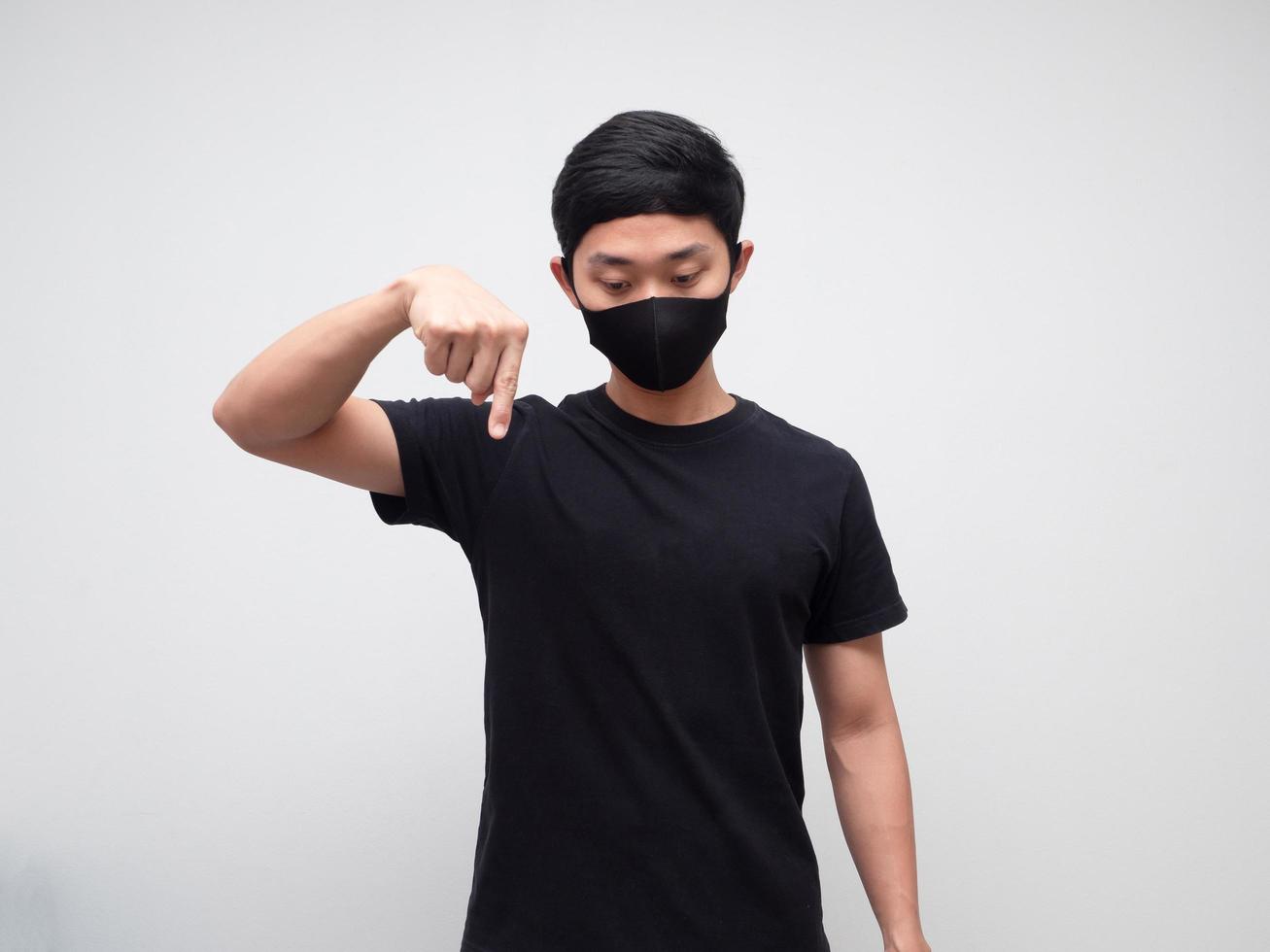 Asian man with protect mask point finger down photo