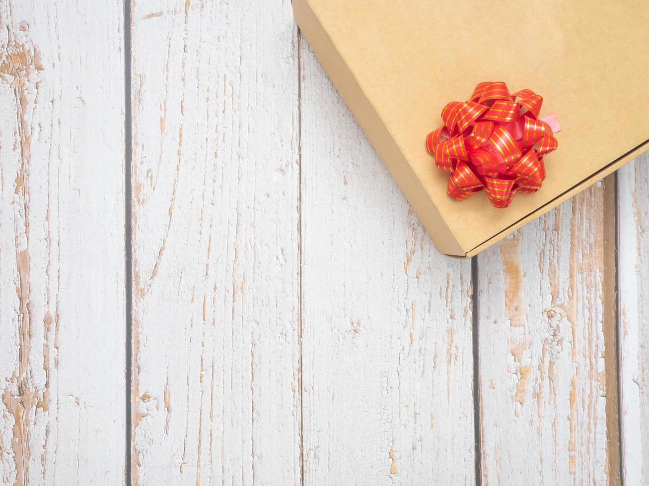 Close up gift box red ribbon on old wood top view copy space photo