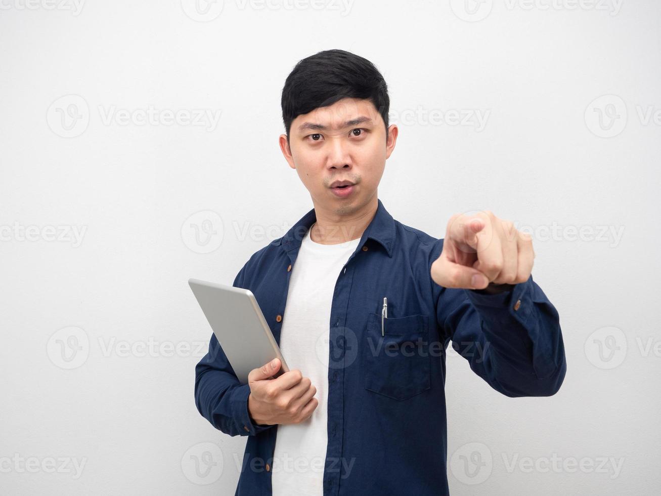 Man with tablet serious face point finger at you photo