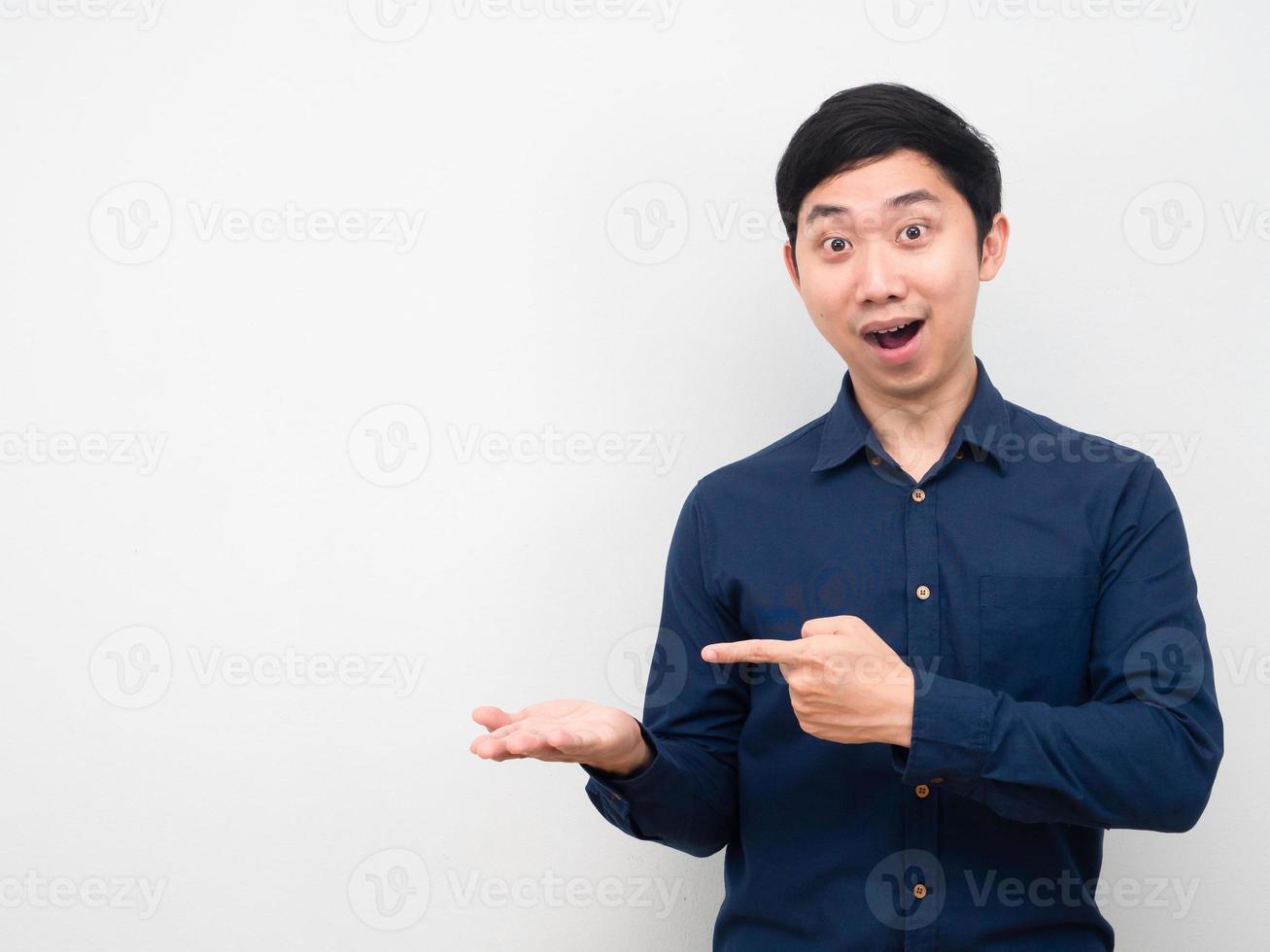 Asian man show empty hand up and point finger copy space photo