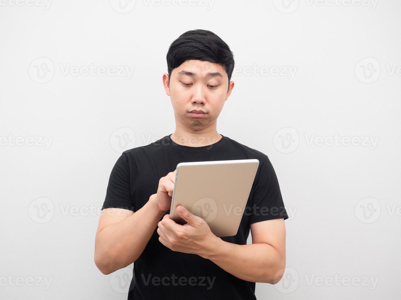 Man using tablet feeling tried with checking work photo