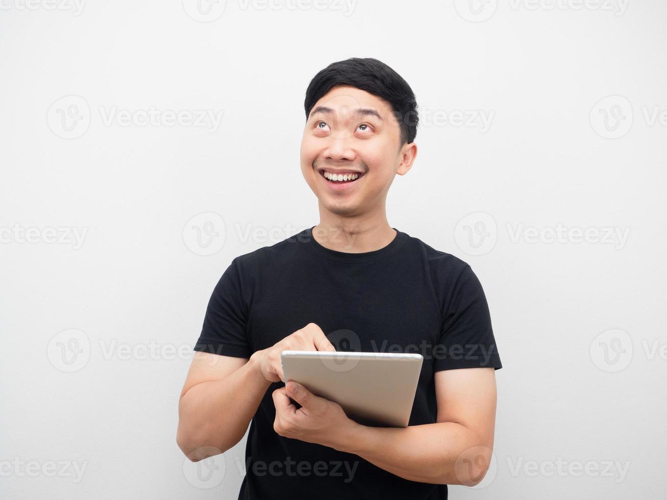 Man happy smiling using tablet looking above photo