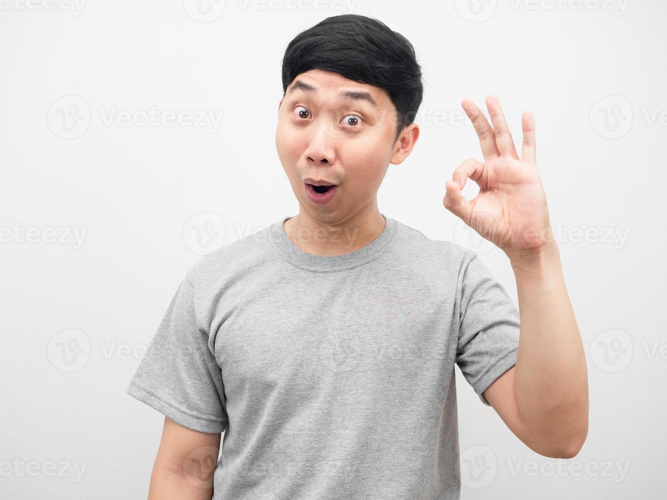 Asian man grey shirt cheerful hand ok white background photo