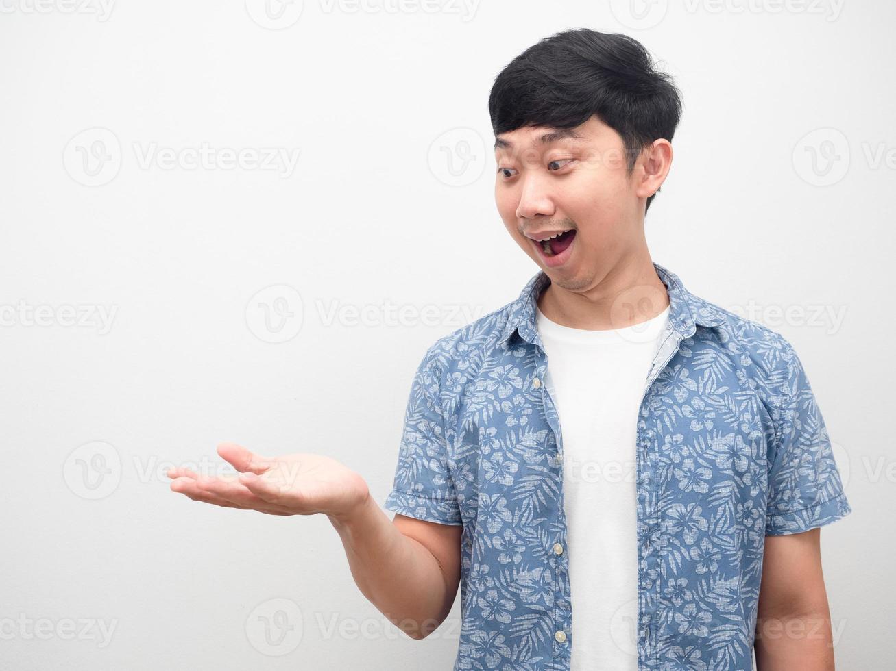 Asian man blue shirt show empty hand up excited emotion copy  space photo