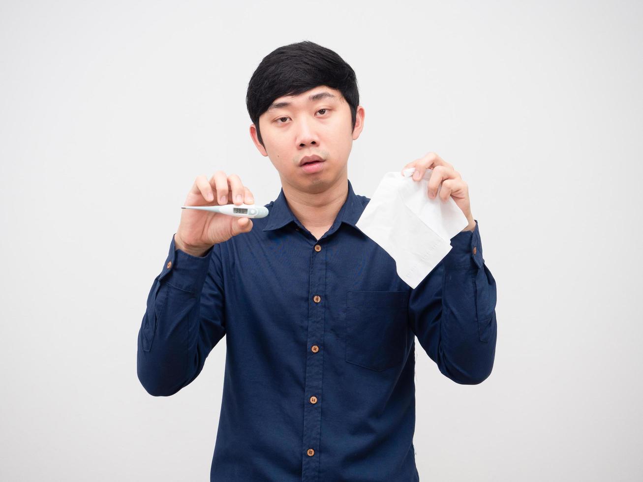 Asian man sick show thermometer and tissue paper in hand unwell face white background photo