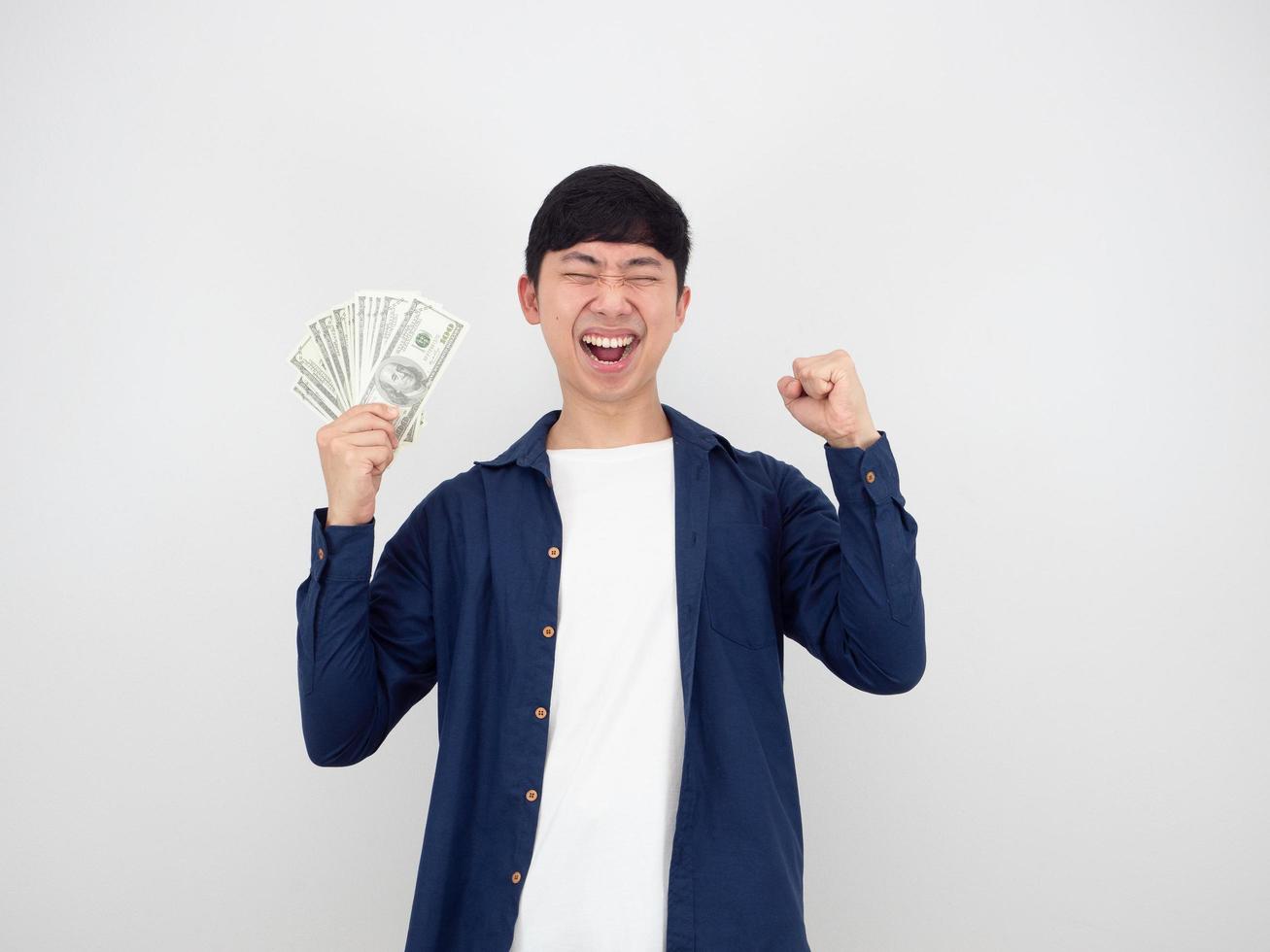 Asian man happy face with money in hand and fist up on white isolated background photo
