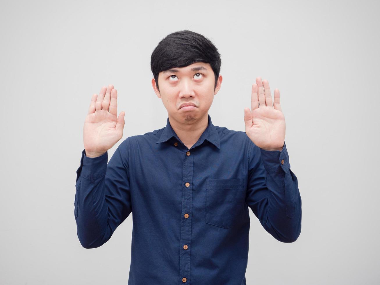 Man feeling bored looking up and show hands up on white background photo