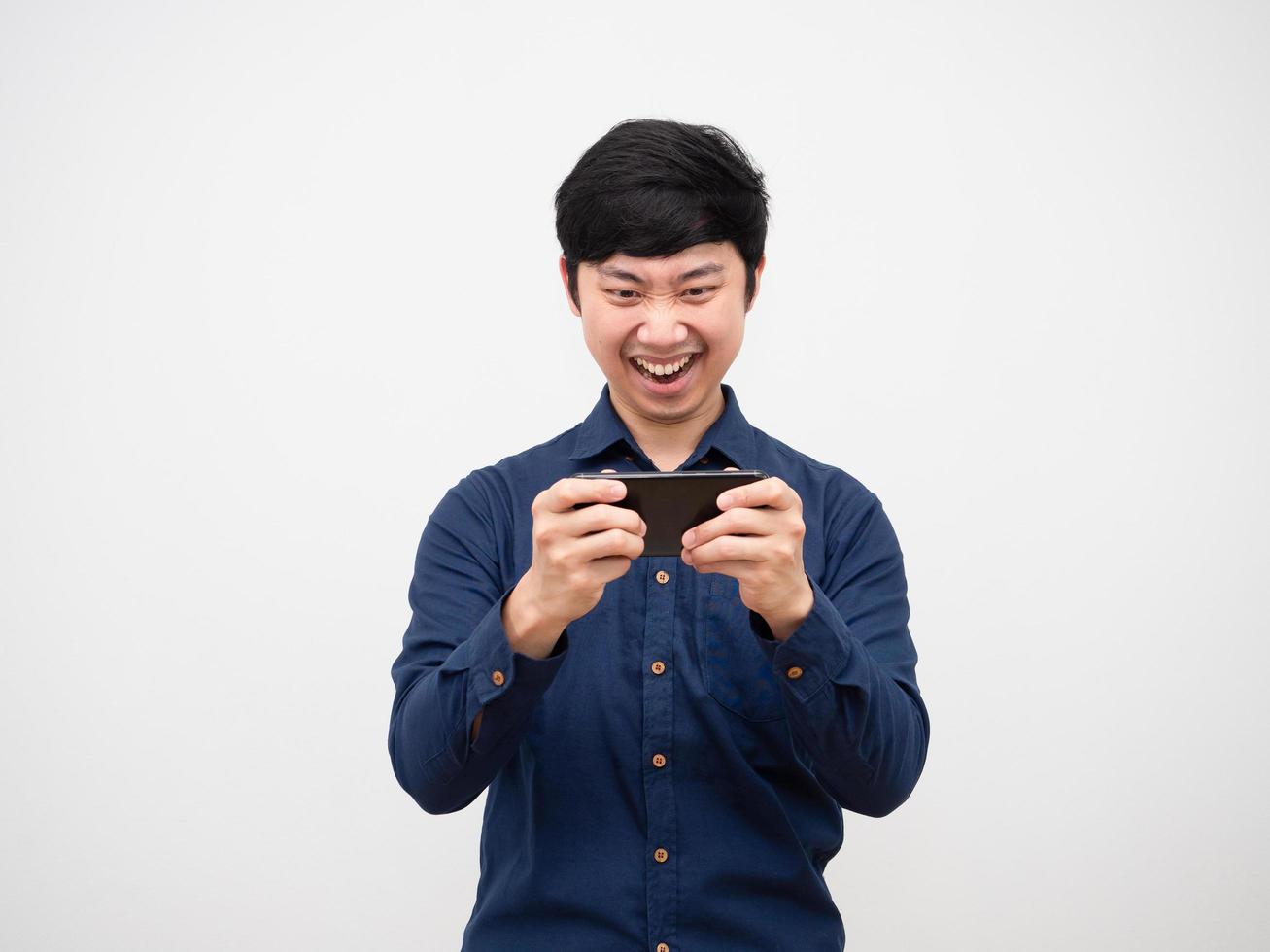 Asian man playing game on mobilephone feeling fun on white background photo