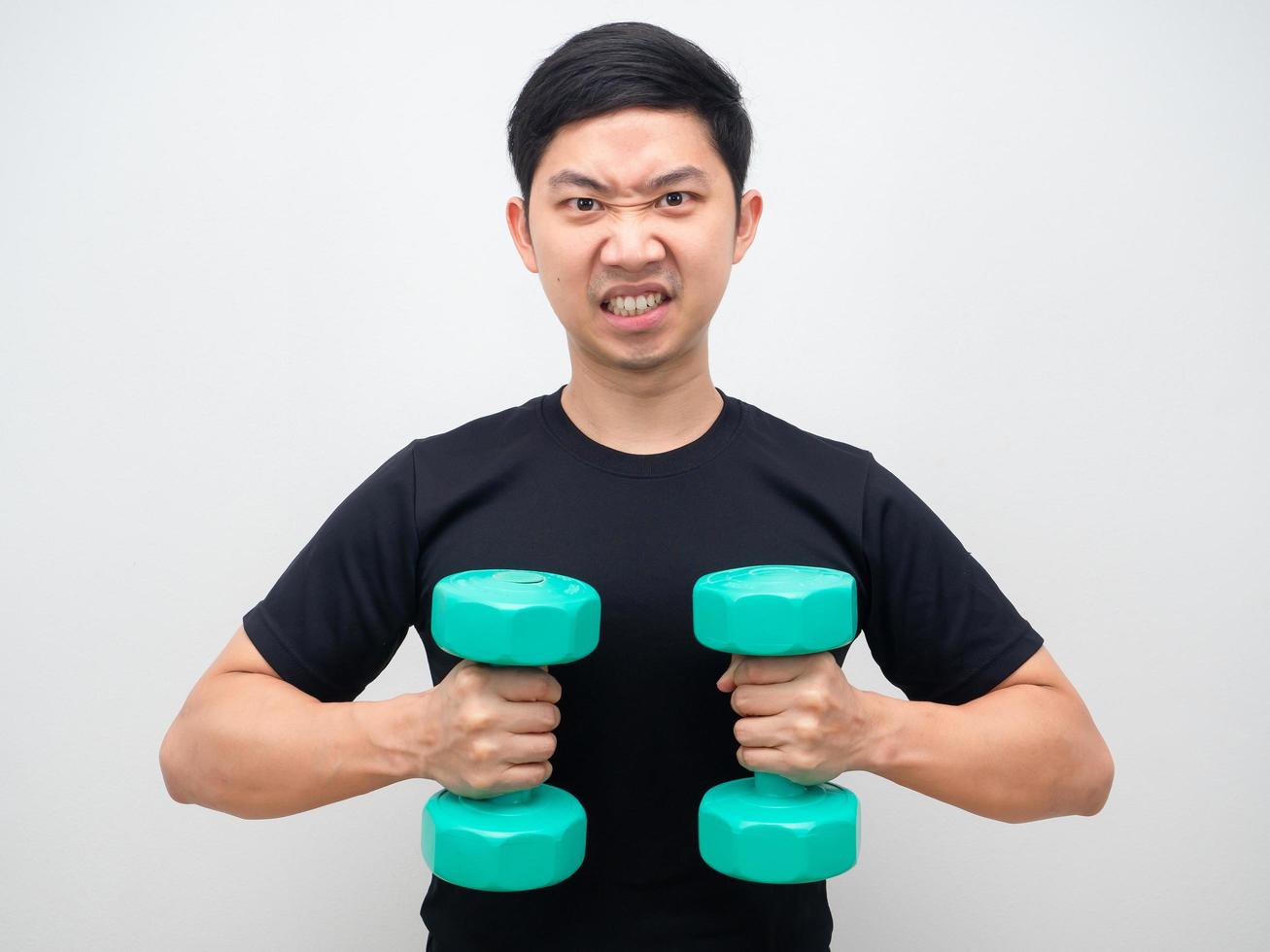 Asian man holding drumbbell feeling confident and motivation himself white background photo