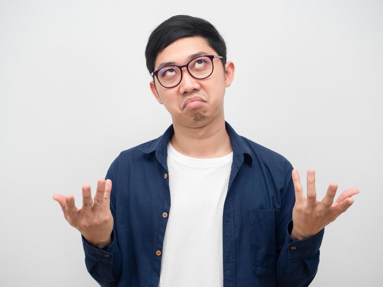 Asian man wearing glasses feeling bored show hand up white background photo