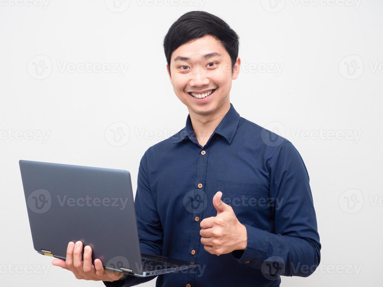 Portrait man holding laptop show thumb up happy smile photo