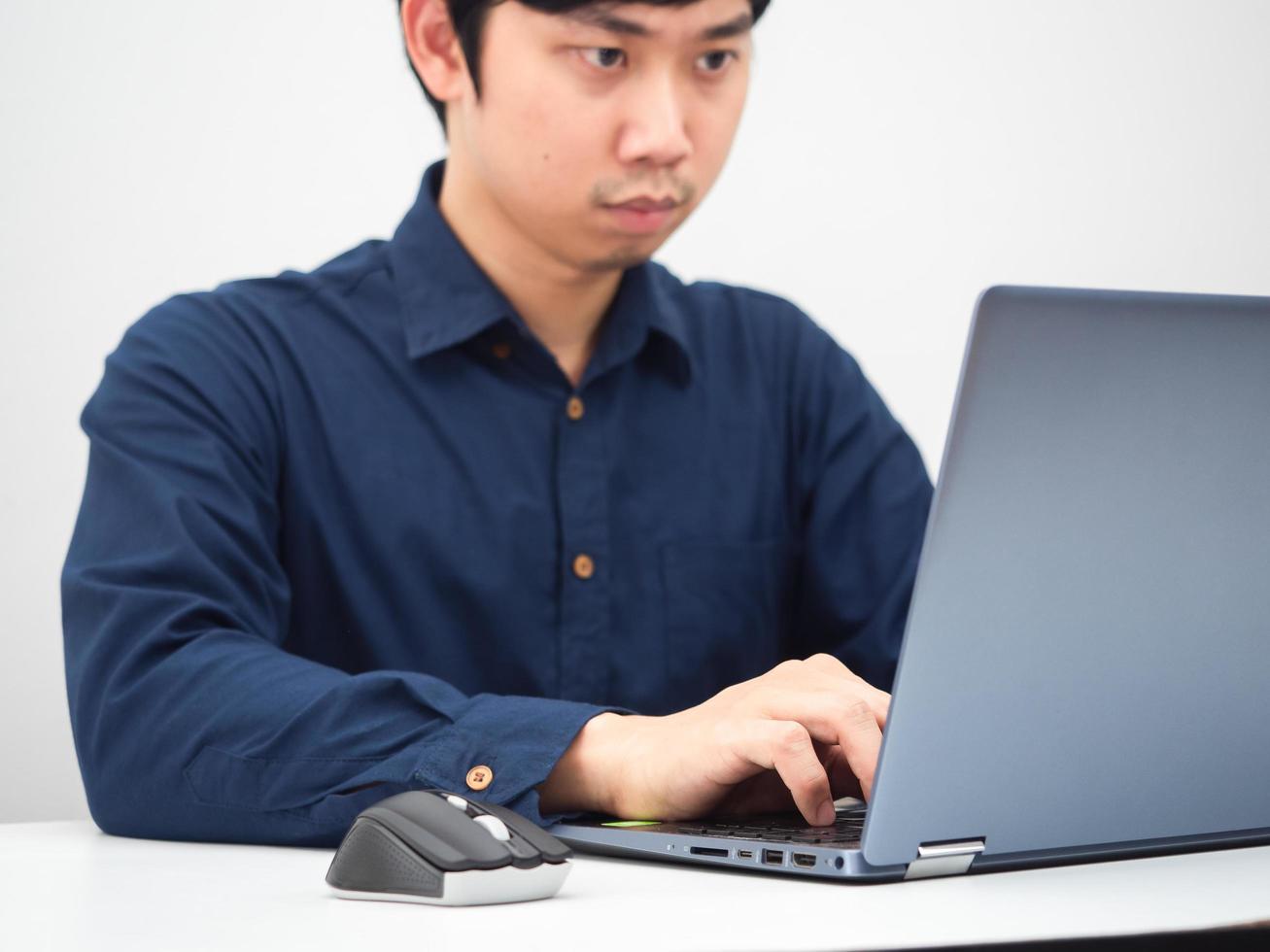 Asian man working with his laptop on the table at home photo