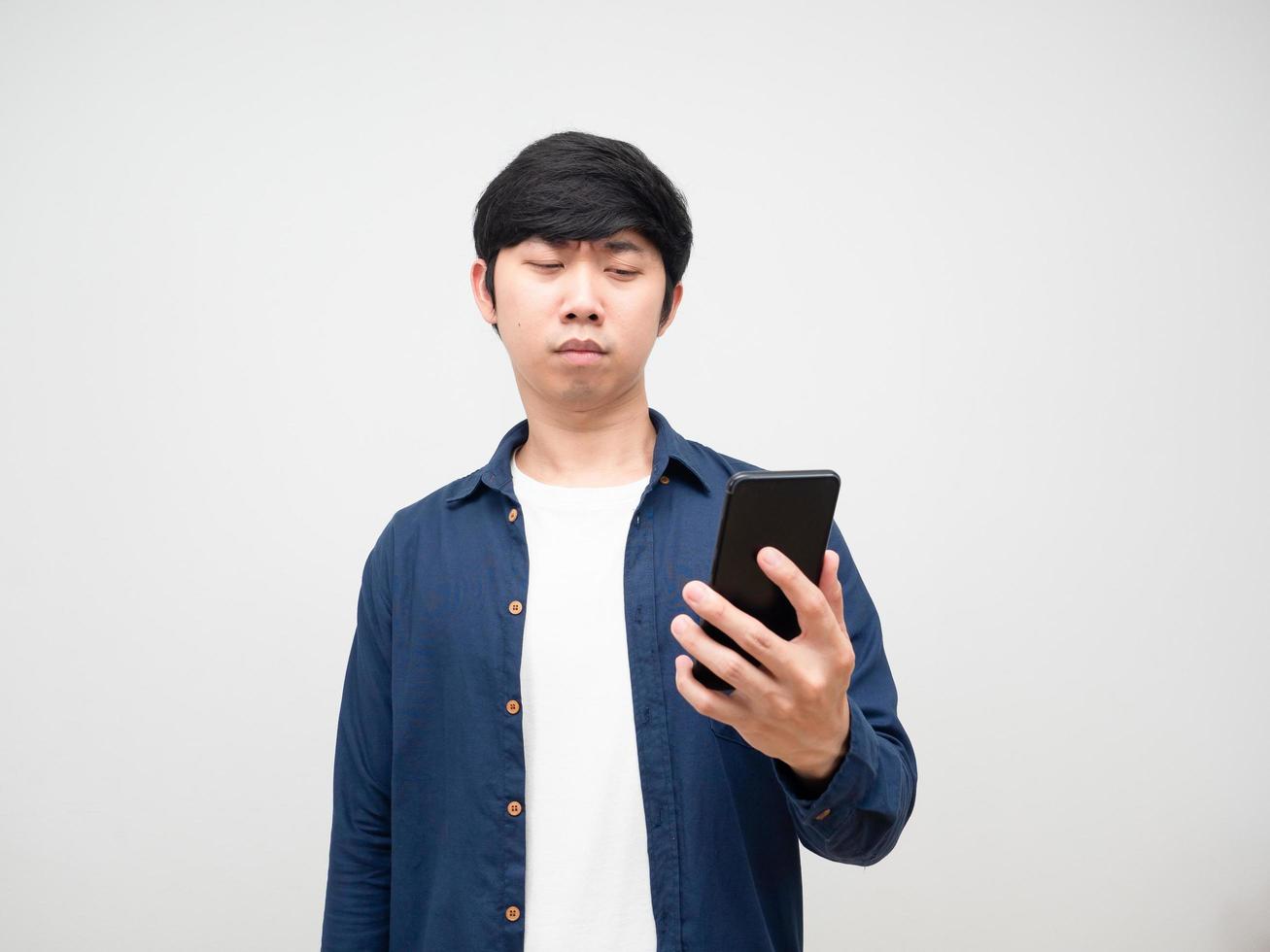 Young man try to looking at mobile in his hand eyes problem photo