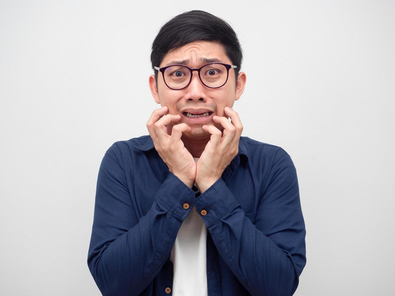 Asian man feeling fear something show hand up at his face photo
