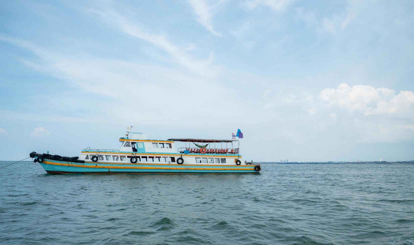 Tourism ship on the ocean and blue sky landscape,Travel boat concept for transport traveler in Thailand with beautiful sea and sky photo