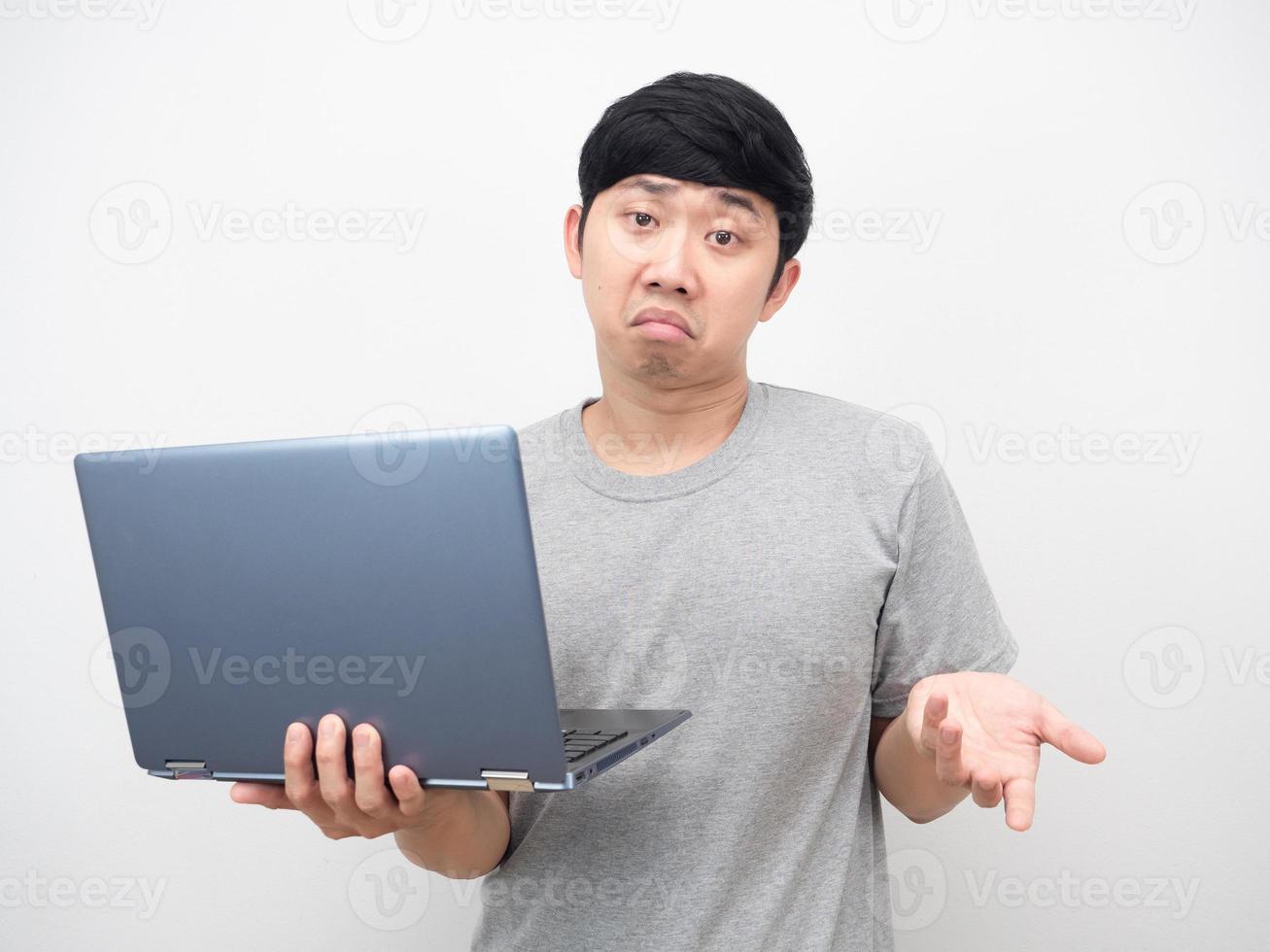 Asian man holding laptop gesture bored photo