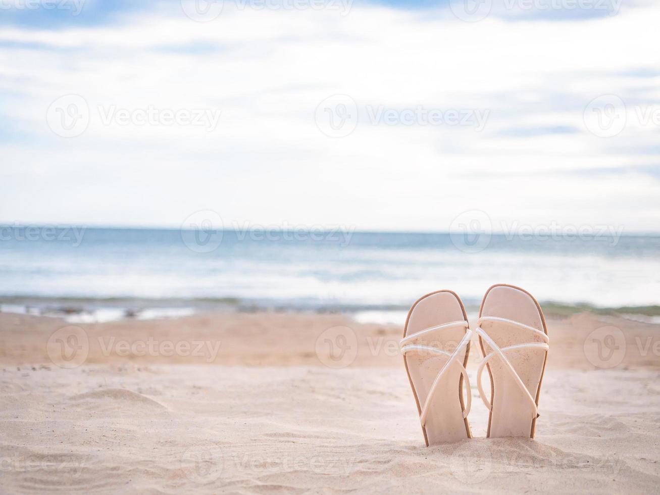 Woman shoe on the beautiful beach blue ocean and sky background copy space photo