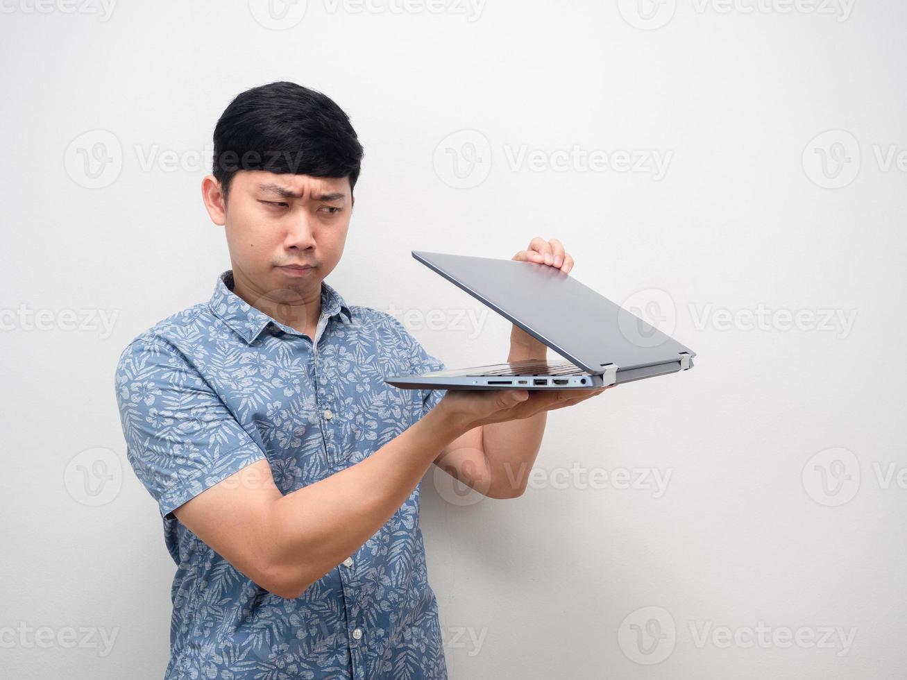 Asian man blue shirt half open laptop in hand gesture spying and feel afraid content photo