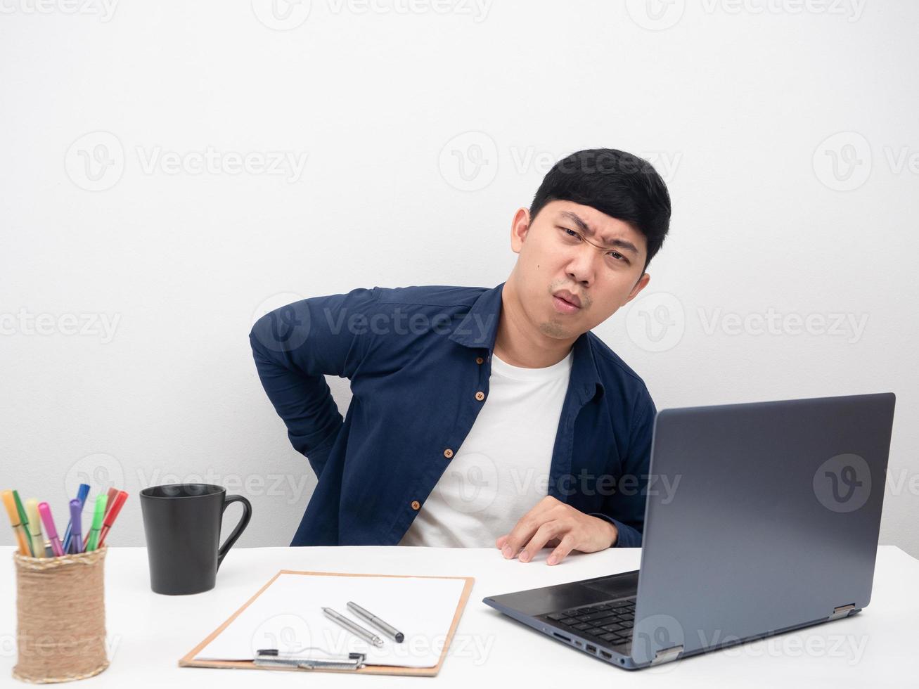 Man employee sitting at office workplace gesture headache office syndrome concept photo