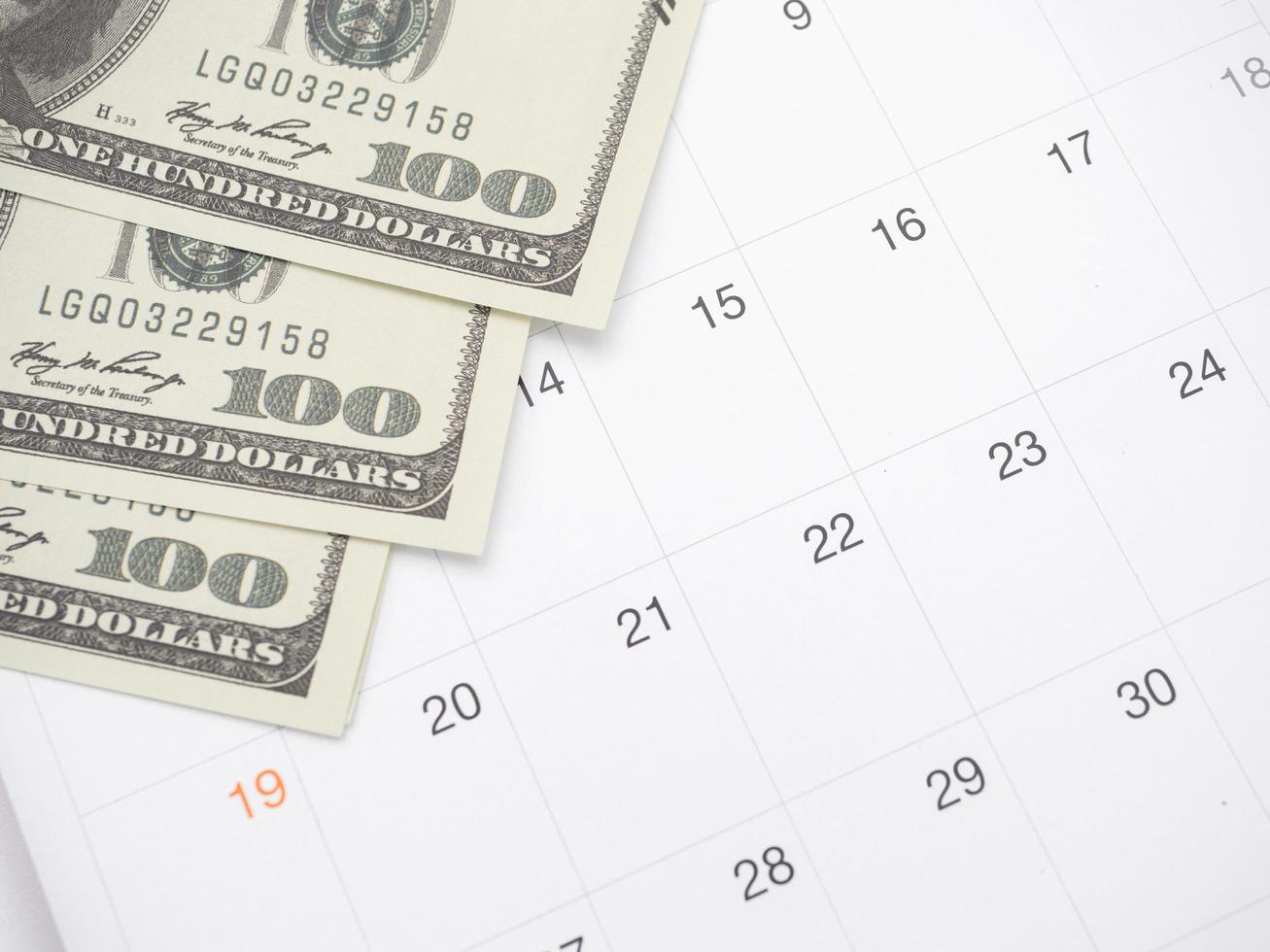 Closeup money on table of calendar photo