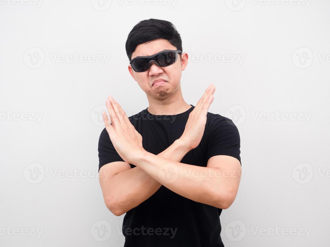 Man wearing sunglasses gesture cross arm for disagree white background photo