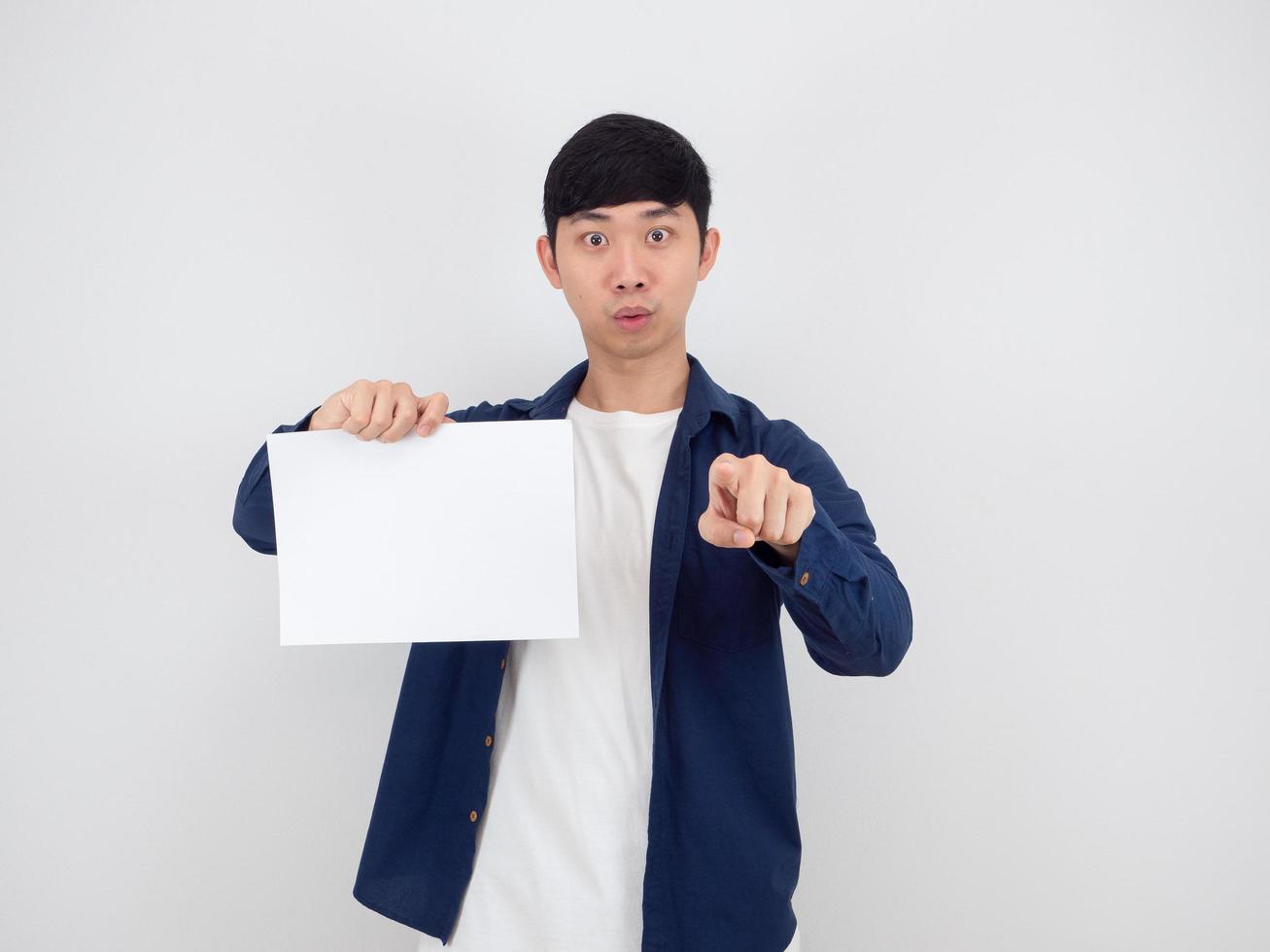 Asian man handsome holding blank paper point at you on white background photo