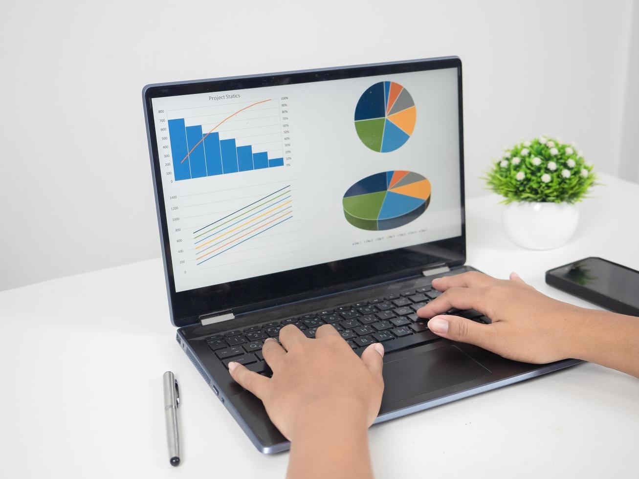 Close up hand using laptop charts graphs business at screen on the table copy space photo