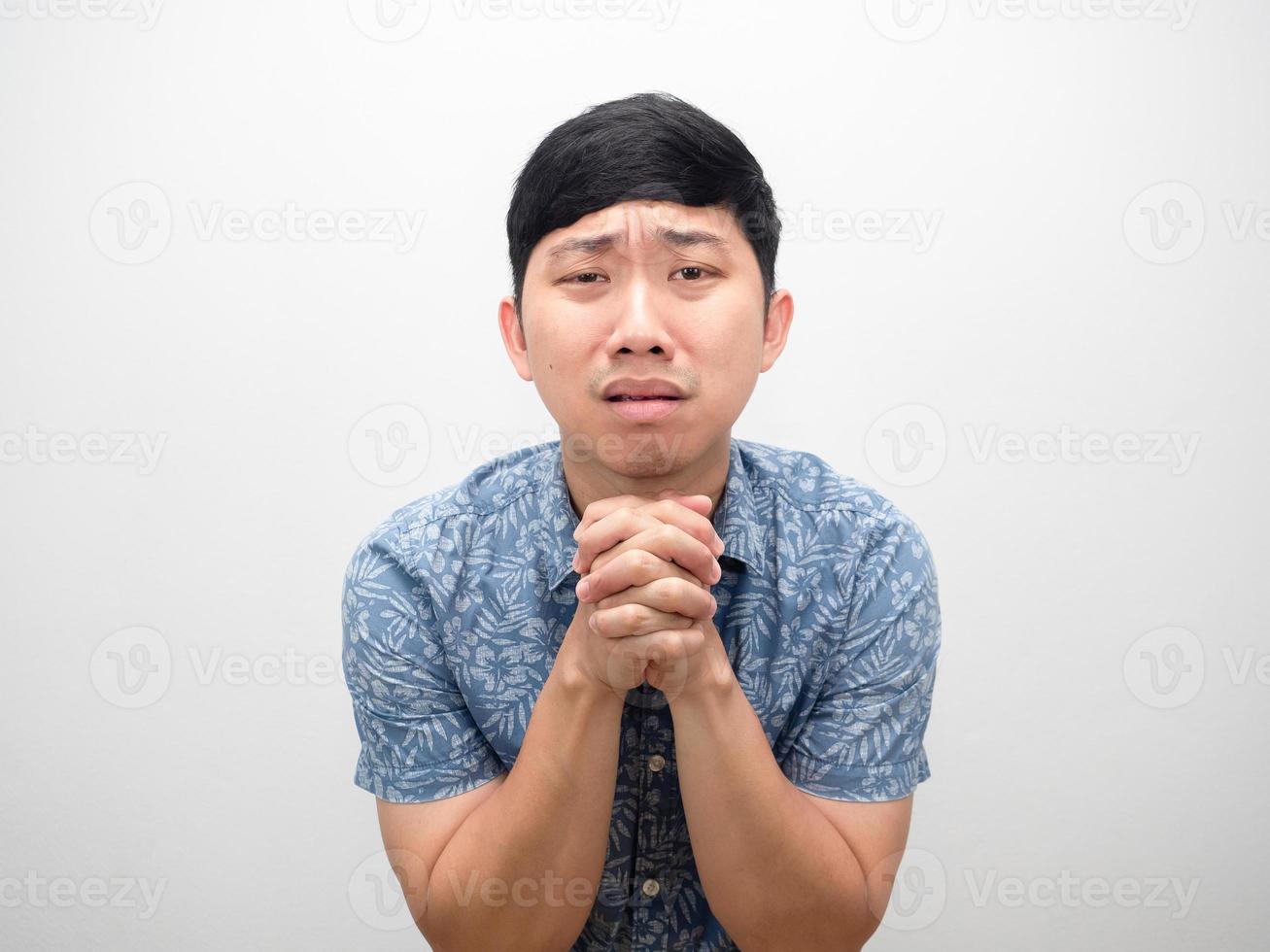 Asian man blue shirt gesture need forgiving me please isolated photo