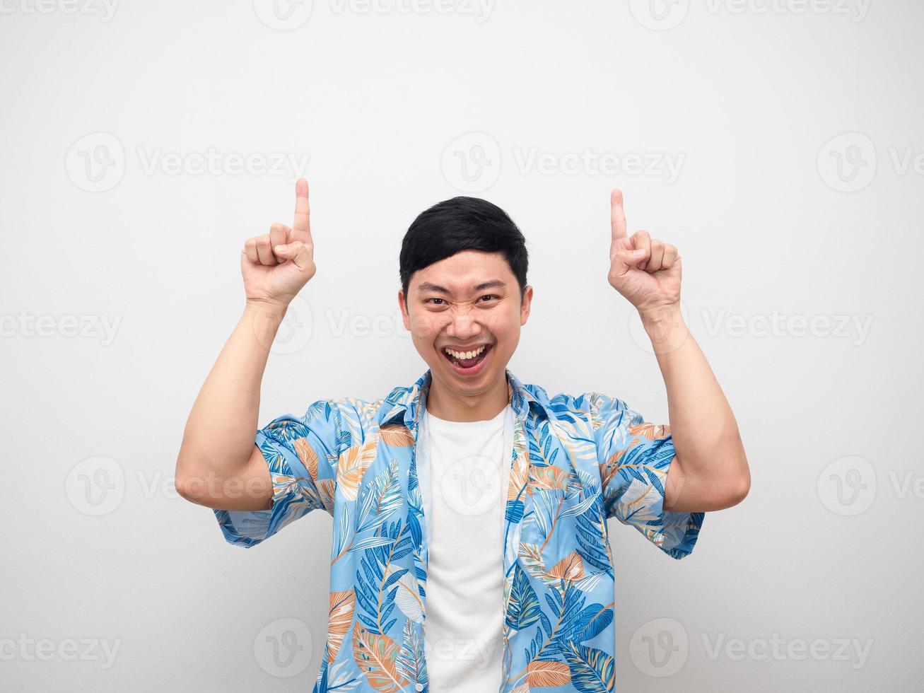 Man delighted emotion point finger above copy space smile face photo