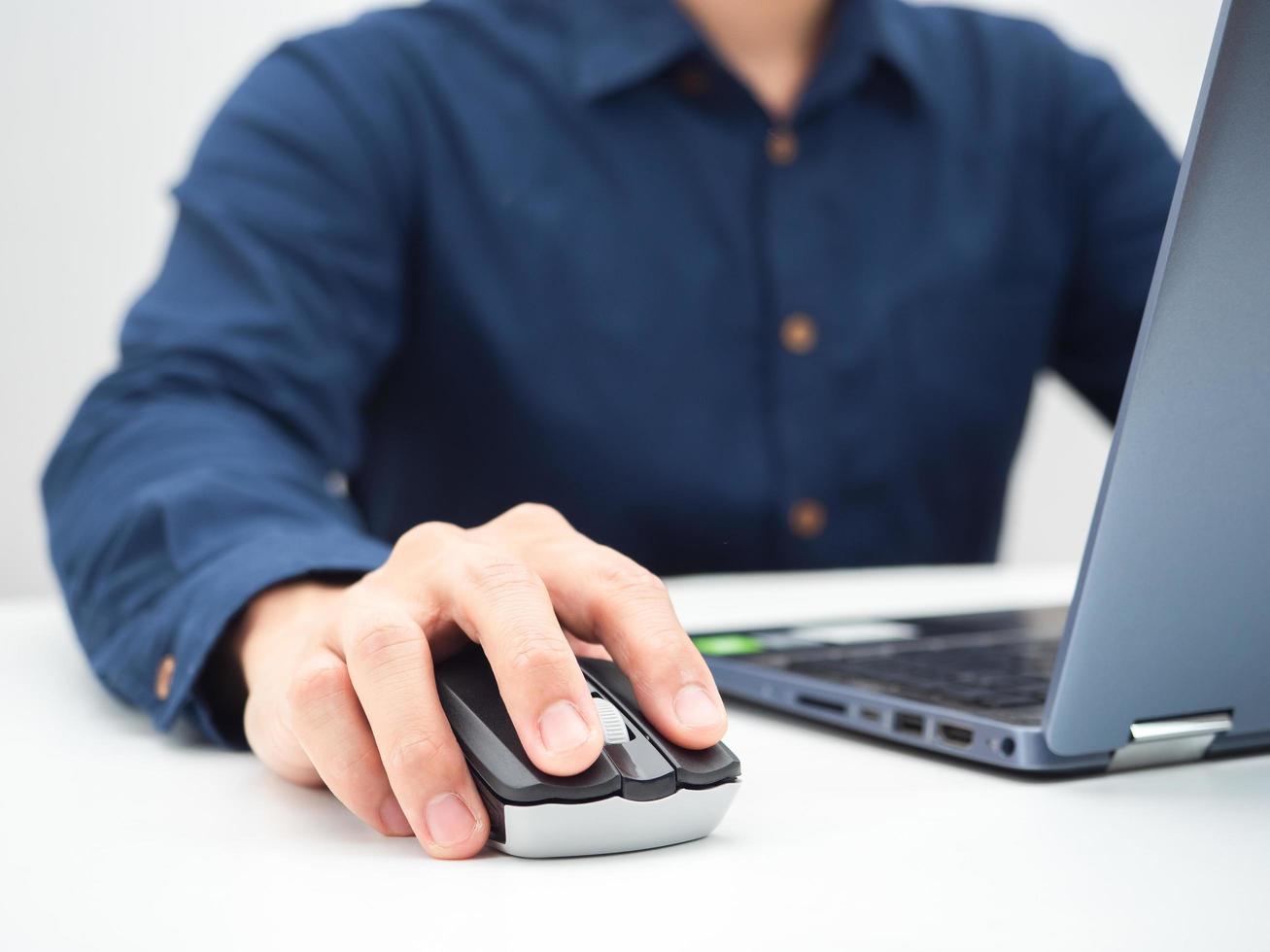 Close up man hand on mouse laptop working from home concept photo