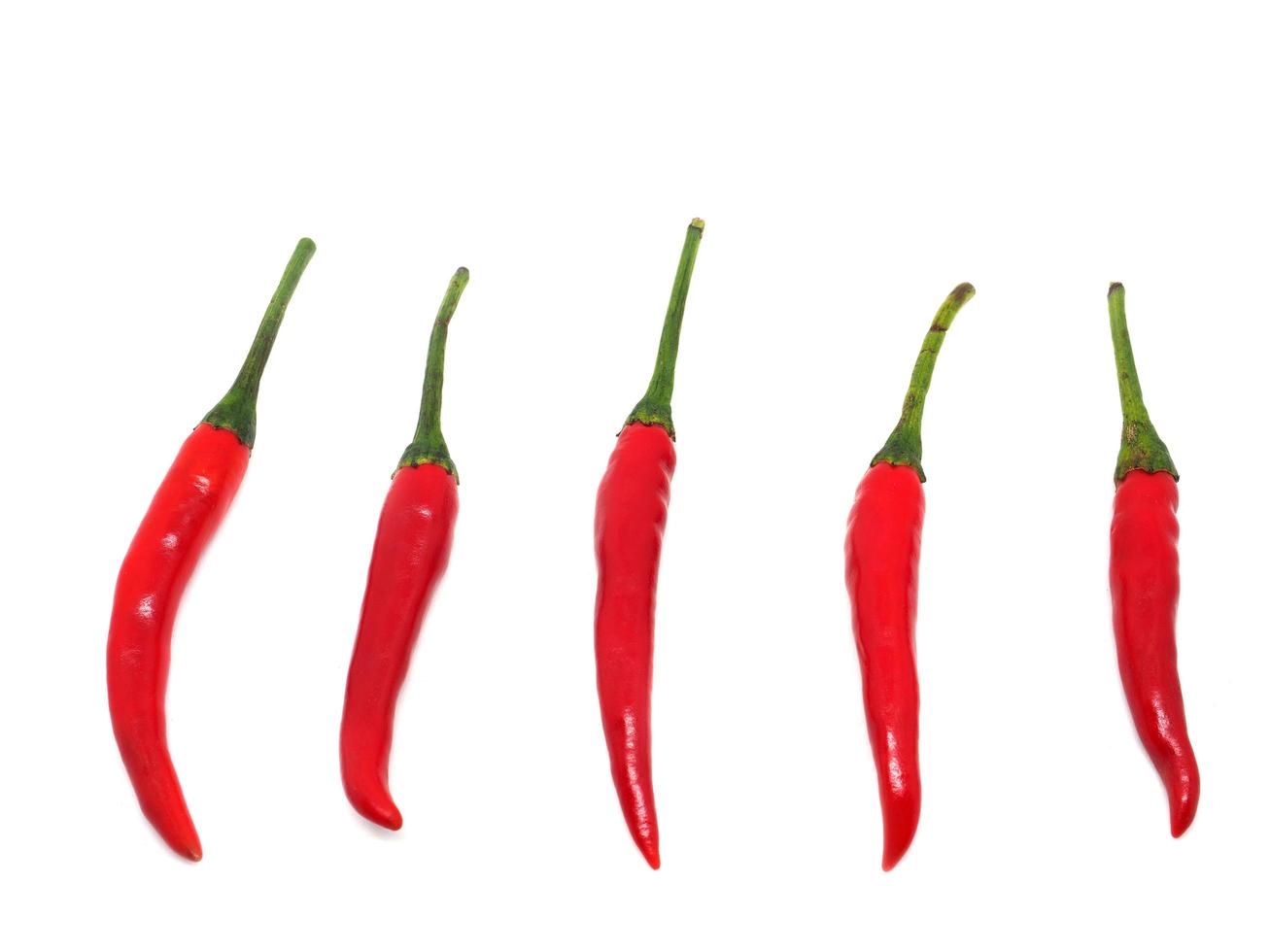 Many red chilli peppers on white isolated photo