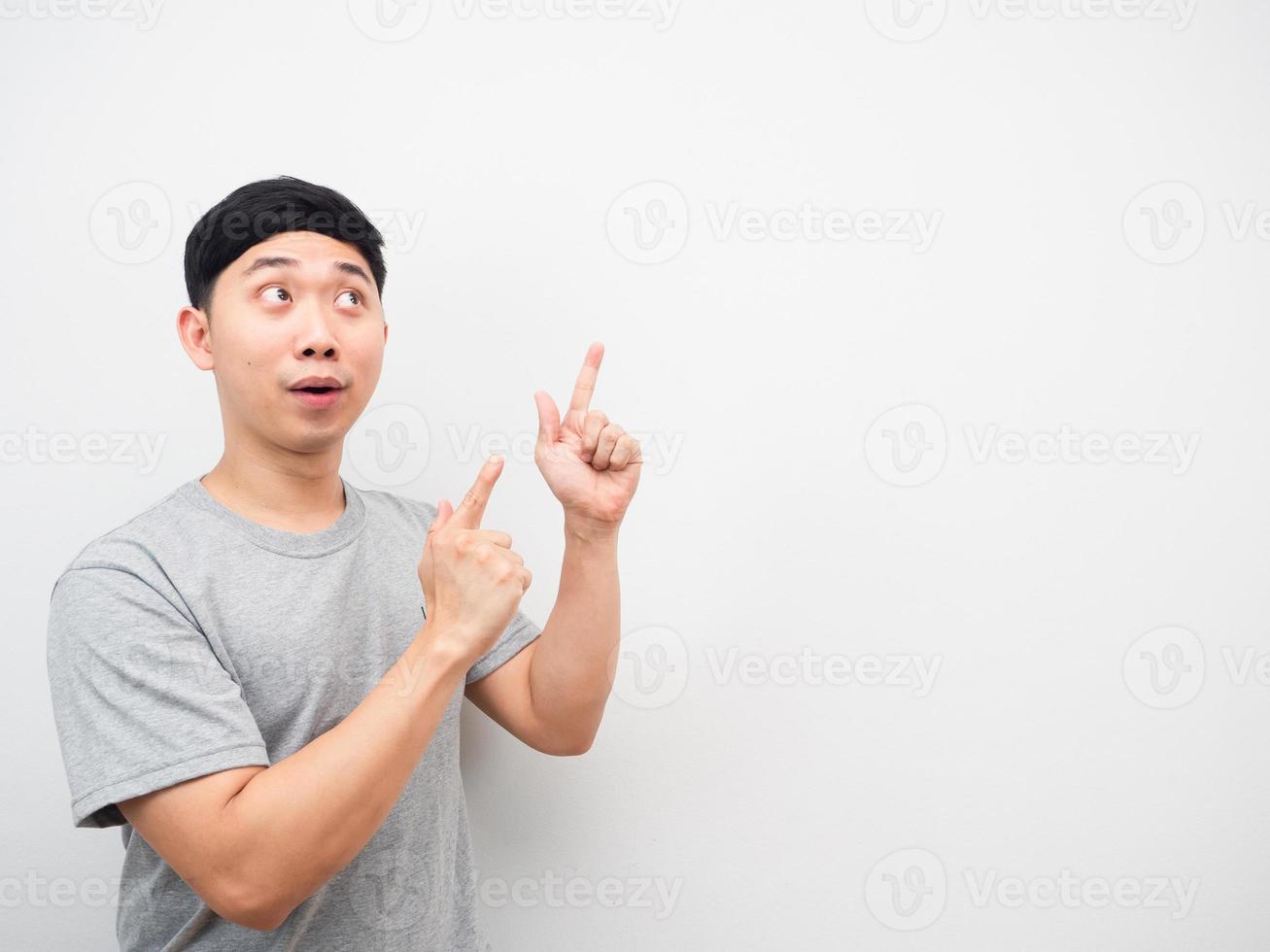 Man grey shirt point finger at copy space white background photo