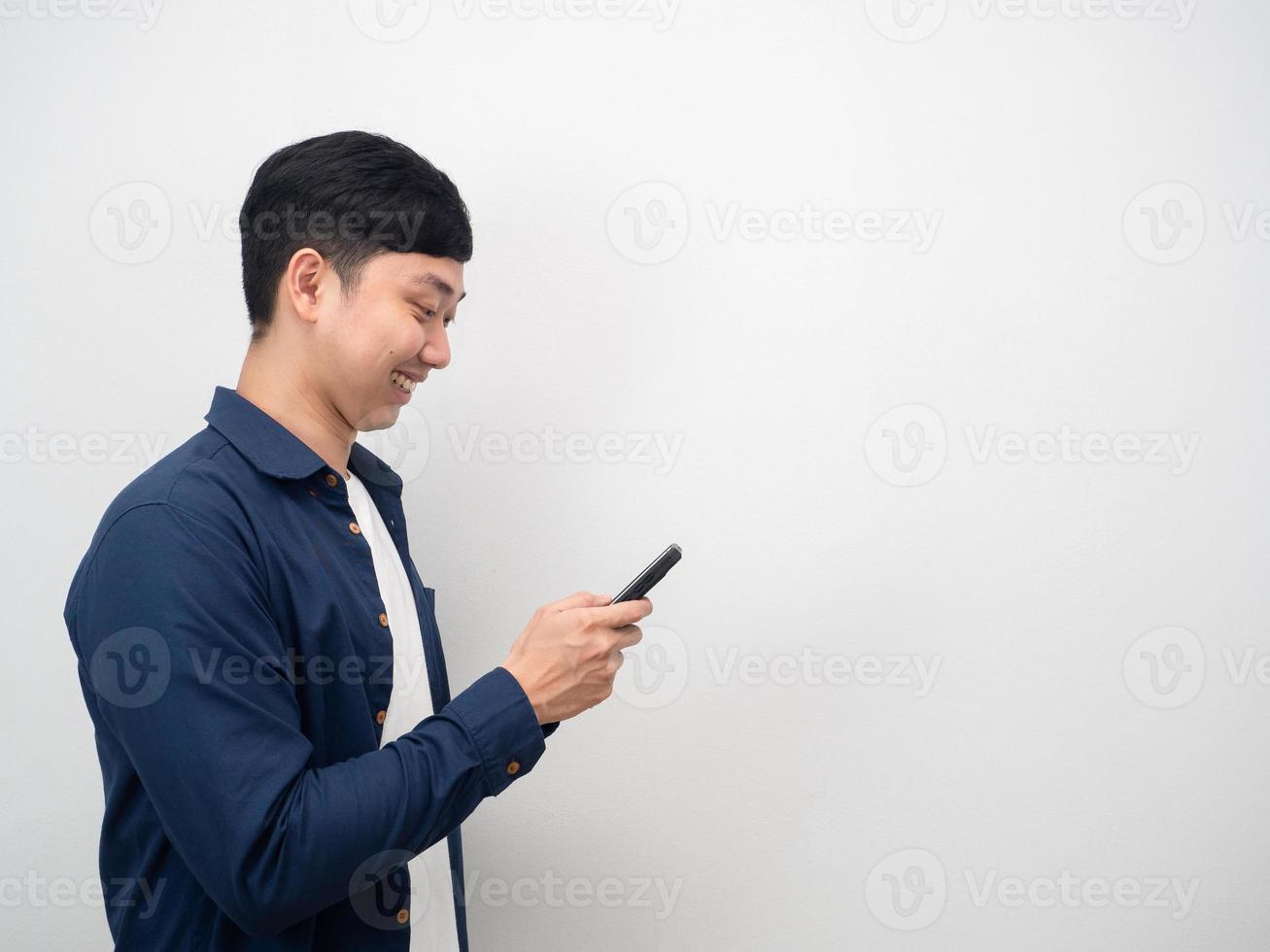 Man playing mobile phone happy smile side view copy space photo
