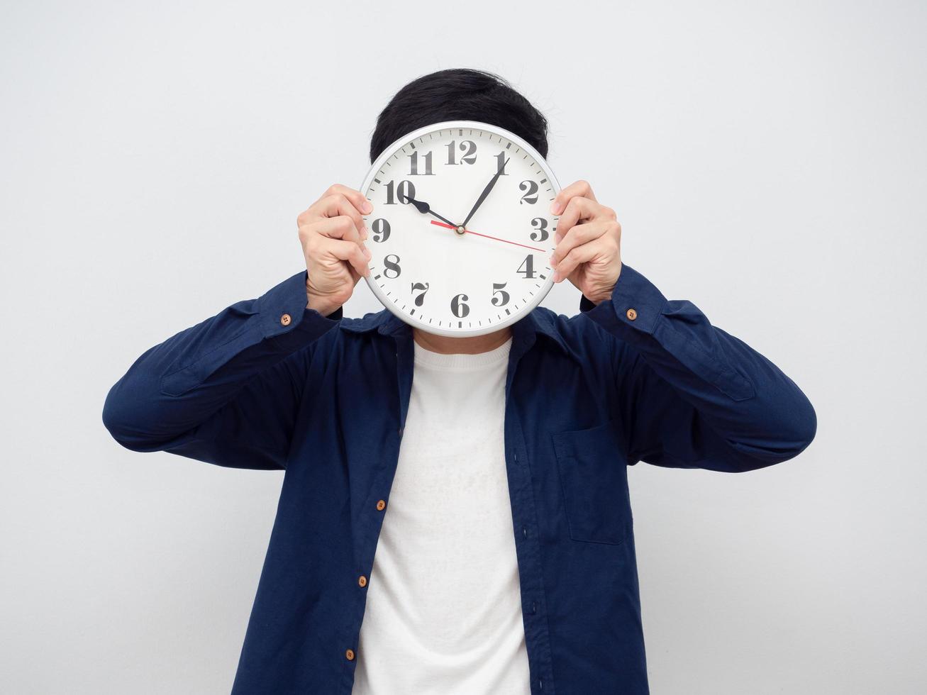 Man holding analog clock close his face portrait photo