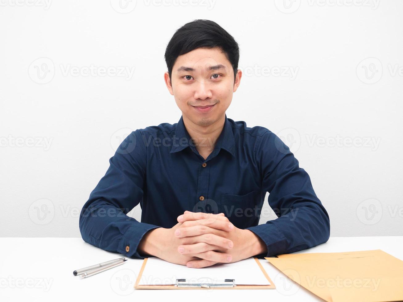 Asian man sitting at his workplace smile face happy emotion white background photo