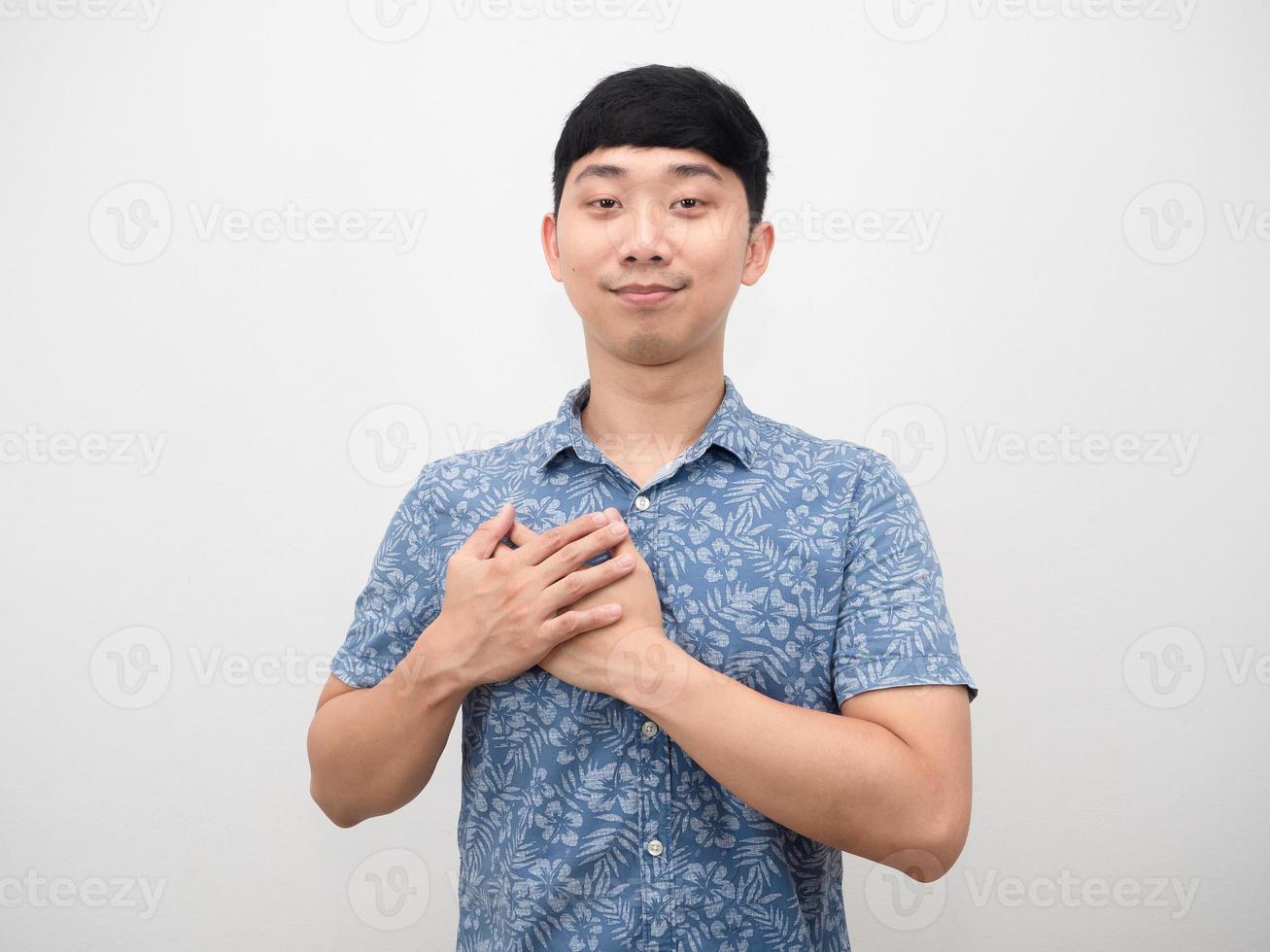 Asian man blue shirt cheerful and touch his chest feeling hopeful photo