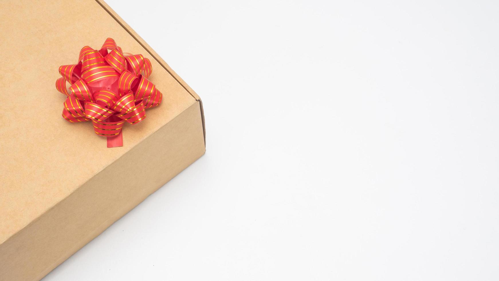 Close up gift box red ribbon on white table top view copy space photo