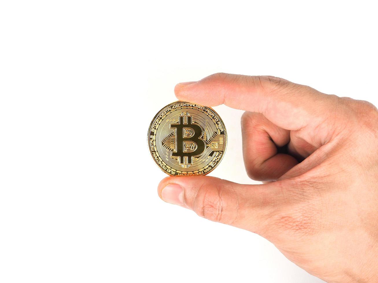 Finger hold bitcoin golden on white isolated,Hand hold gold bitcoin crypto ditital money concept photo