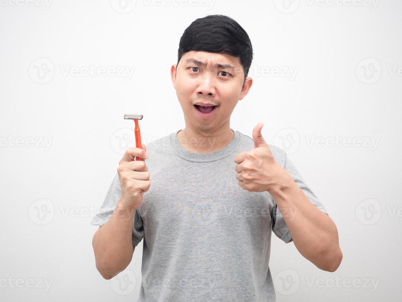 Man holding shaving feeling good and thumb up photo