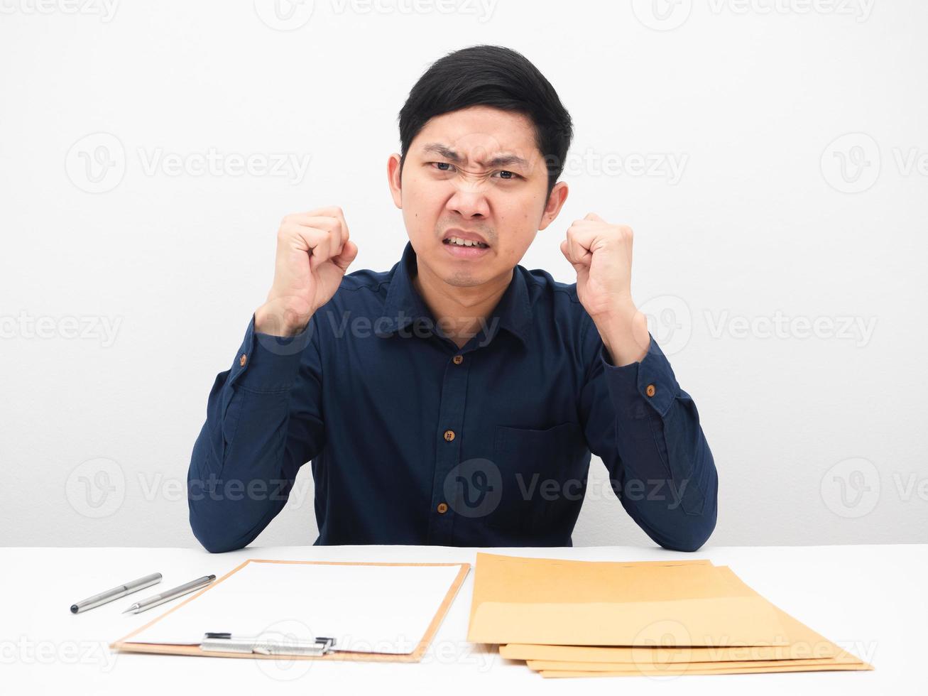 Man sitting at the table with many document envolope feeling angry emotion photo
