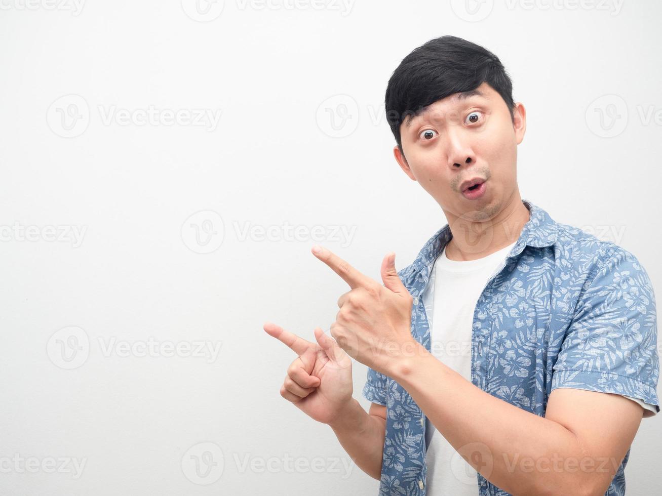 Man excited face point finger at copy space isolated photo