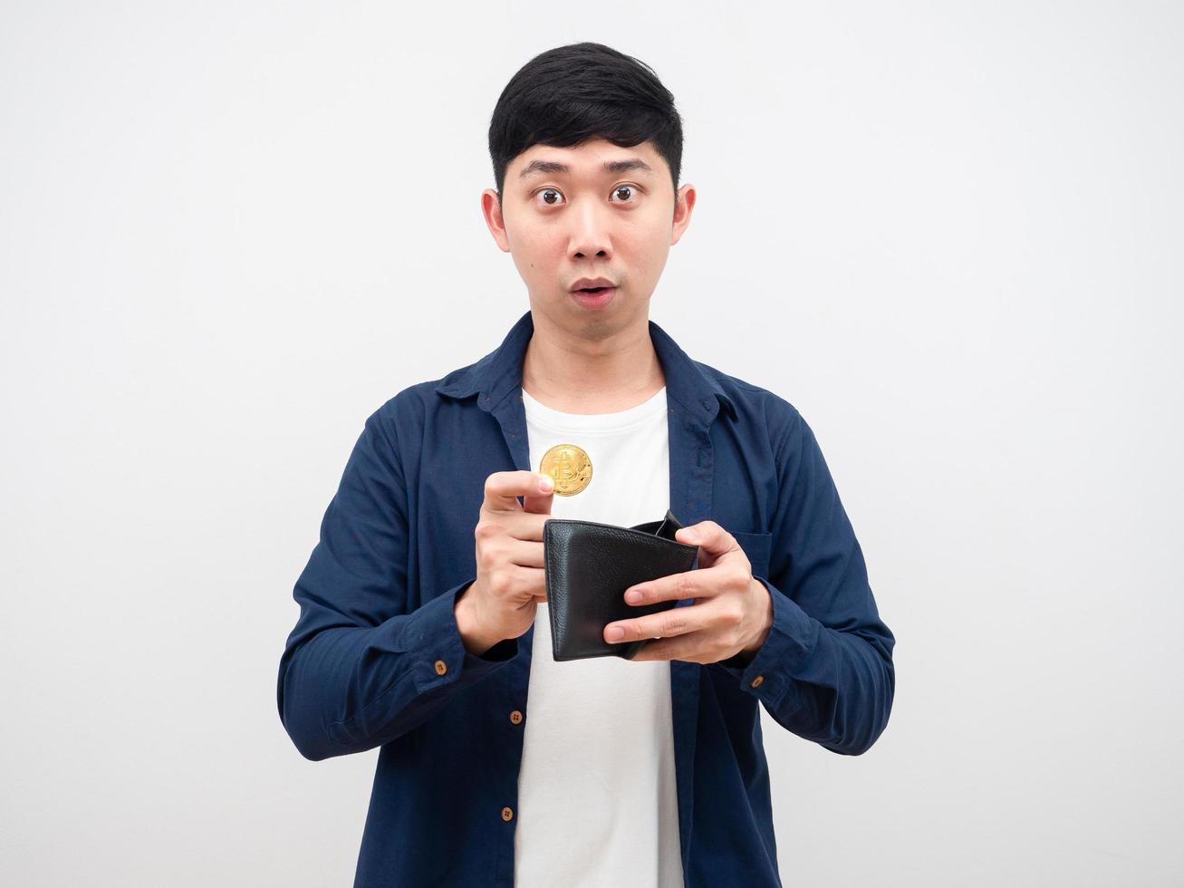 Asian man pick up bitcoin from his wallet feeling amazed at face on white background digital money concept photo