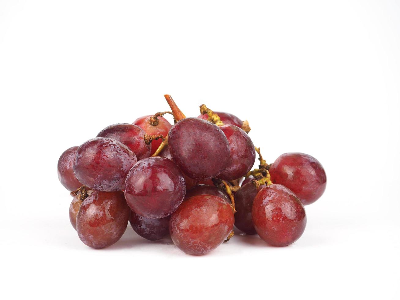 Red grapes ripe with branch on white isolated background photo