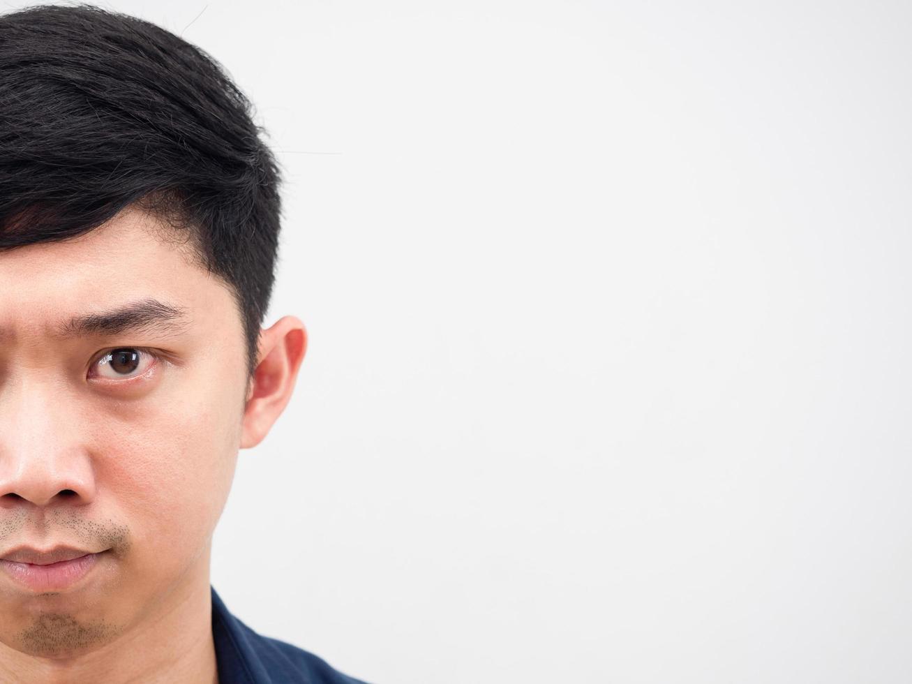 Half face of handsome man serious looking at camera on white isolated photo