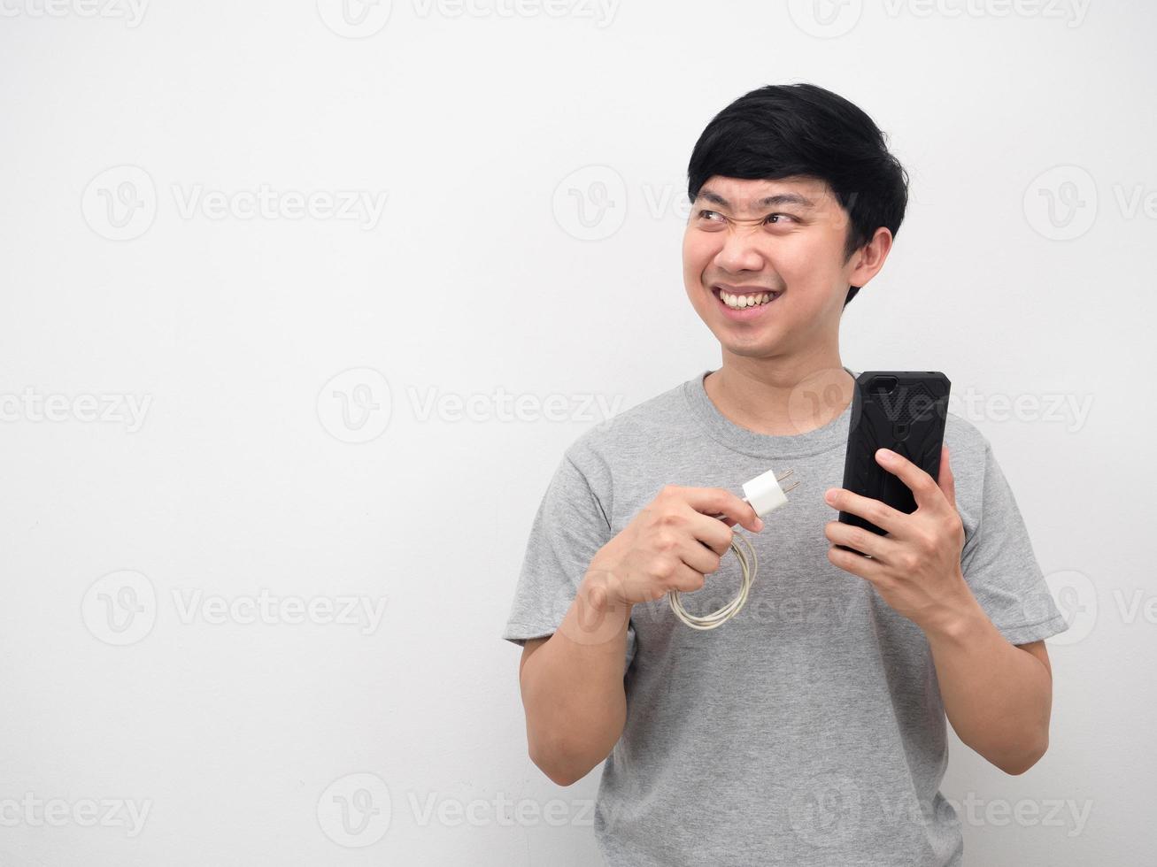 Man holding mobile phone and charging mobile excited emotion copy space photo
