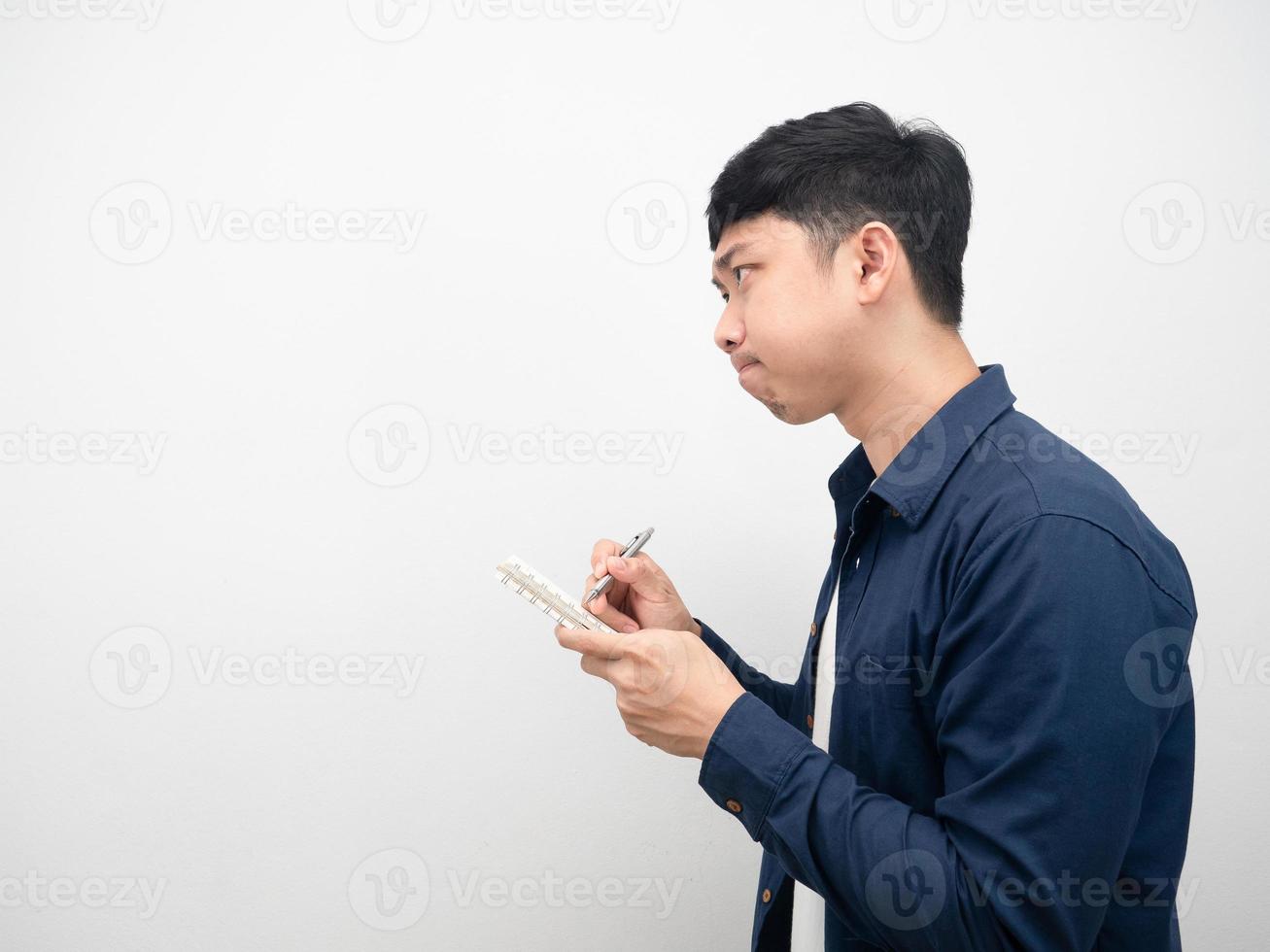 Man note in diary and thinking about job looking at copy space side view photo