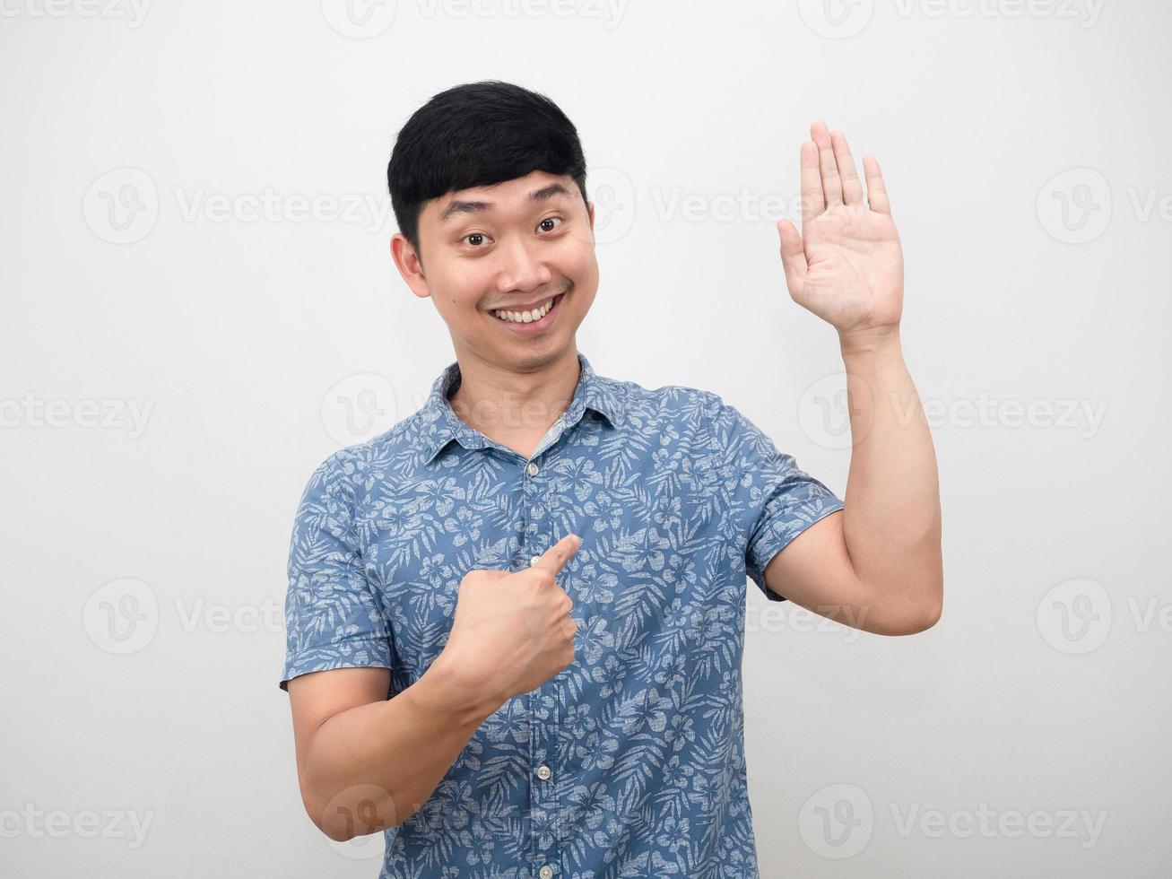 Man smiling hand up surrender and point finger at himself photo